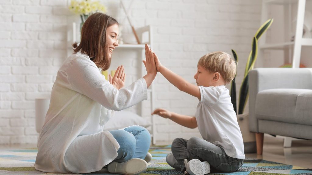 nanny playing with a child in the living room
