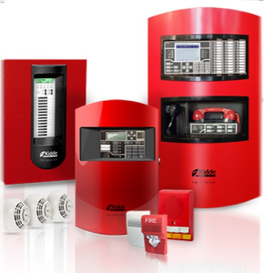 A set of red fire alarm system components is displayed, including control panels, a communication unit, smoke detectors, a manual pull station, and notification devices, representing a complete commercial fire alarm system.